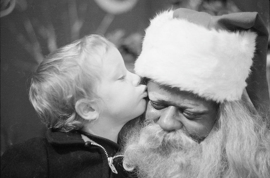 Kissing Santa Claus Photograph by Ralph Morse