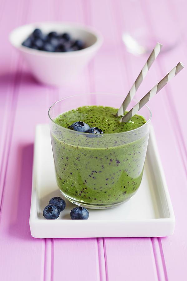Kiwi Smoothie Garnished With Blueberries Photograph by Charlotte Tolhurst