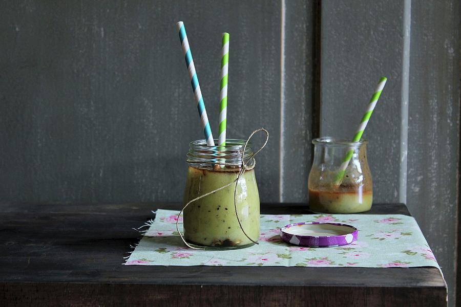 Kiwi Smoothies In Jars With Straws Photograph by Patricia Miceli