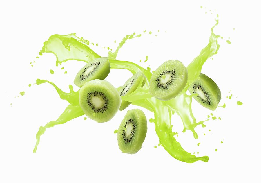 Kiwis And A Splash Of Juice Photograph by Krger & Gross