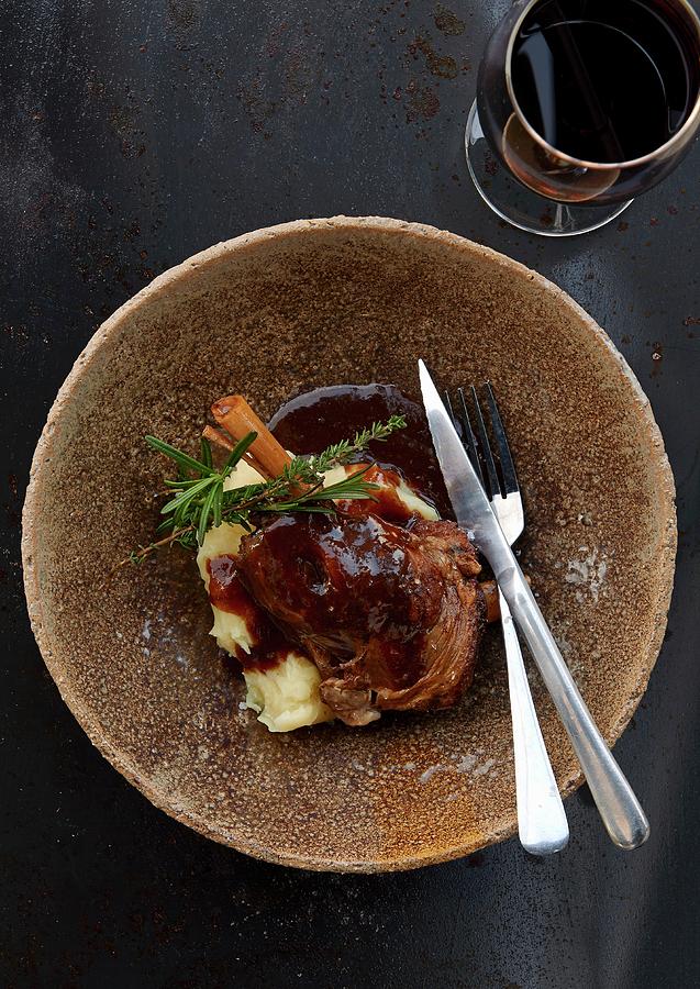 Knuckle Of Lamb On Mashed Potatoes With Red Wine Gravy Photograph by Robbert Koene