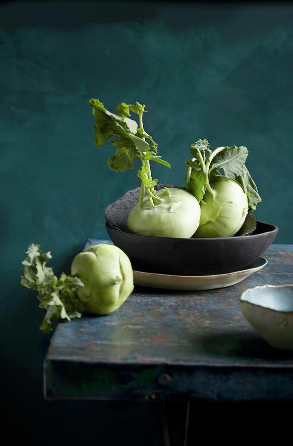 Kohlrabi In A Bowl And On A Wooden Table Photograph by Aina C. Hole