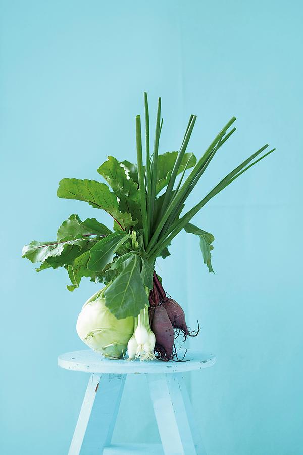 Kohlrabi, Spring Onions And Red Turnips On A Light Blue Stool Photograph by Jalag / Wolfgang Schardt