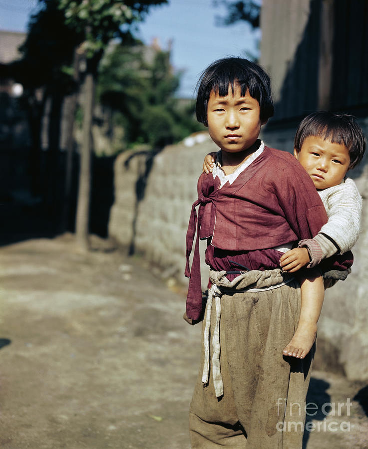 Korean Child Carrying Baby On Her Back Photograph by Bettmann