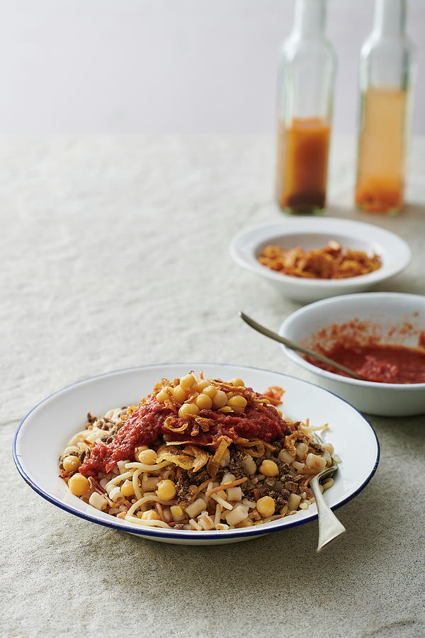 Koshari Traditional Egyptian Dish - Vegan Mixed Rice, Pasta, Lentils, With Caramelized Onions And Tomato Chili Sauce Photograph by Yehia Asem El Alaily