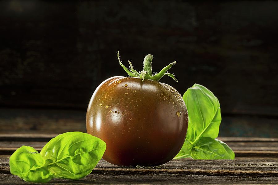 Kumato Tomato And Basil Photograph by Christian Schuster