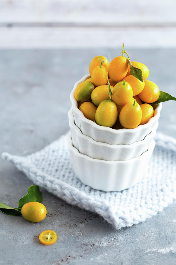 Kumquats In A White Bowl Photograph by Aniko Takacs