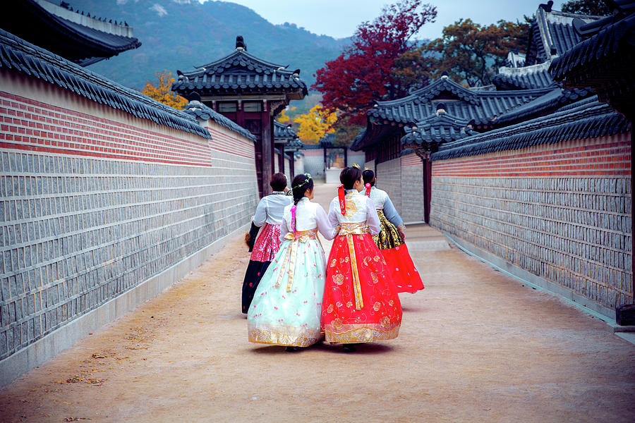 Lady in hanbok dress walk in seoul palace in ginkgo autumn garde Photograph by Anek Suwannaphoom