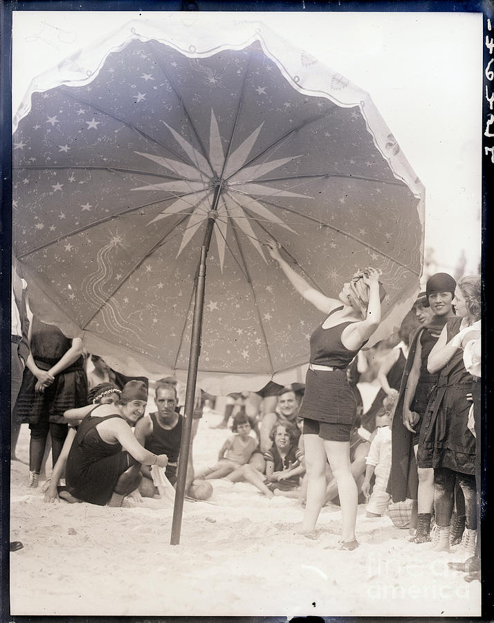 Lady Stands Under Huge Beach Umbrella Photograph by Bettmann
