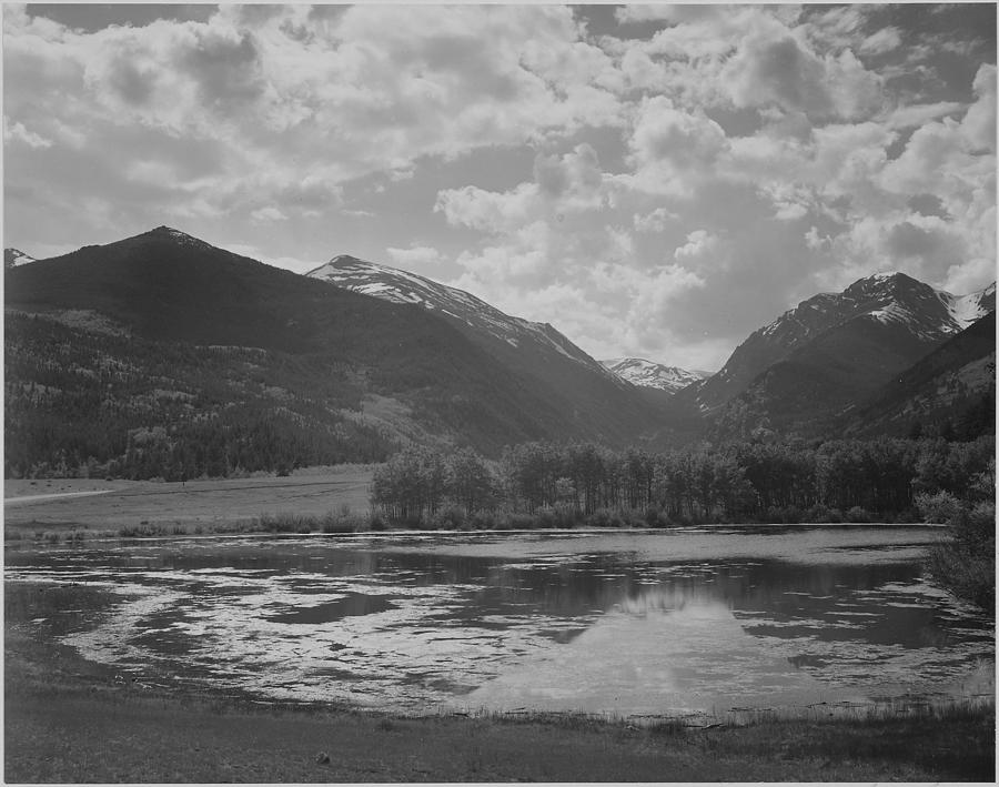 Tree Painting - Lake and trees in foreground mountains and clouds in background In Rocky Mountain National Park Colorado. 1933 - 1942 by Ansel Adams