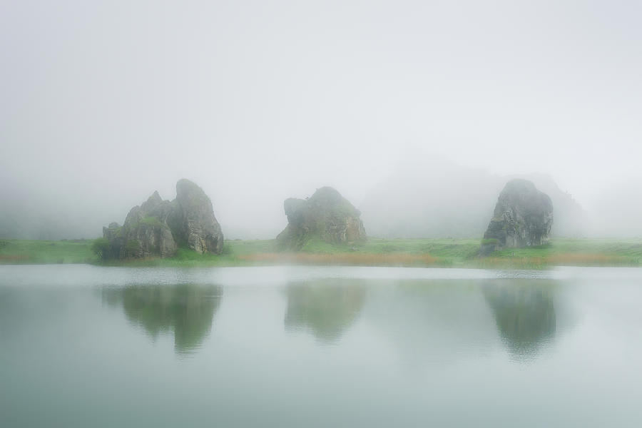 Lake in La Arboleda with some rocks Photograph by Mikel Martinez de Osaba