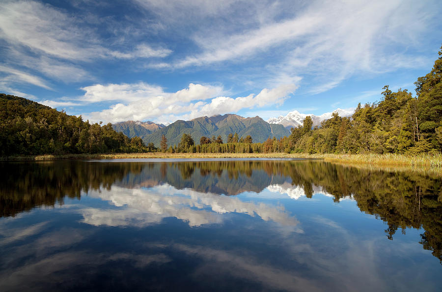 Lake Matheson On New Zealands South Photograph by Simon Bradfield