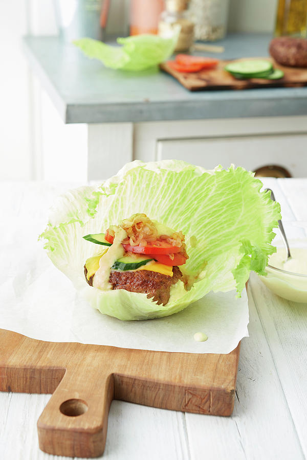 Lamb Burger With Tomato And Cucumber On A Lettuce Leaf Photograph by Nikolai Buroh