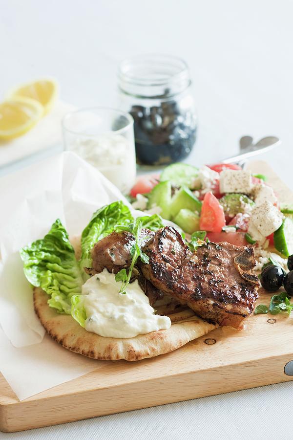 Lamb Chop On Pita Bread, With A Greek Salad And Tzatziki Photograph by Andrew Young