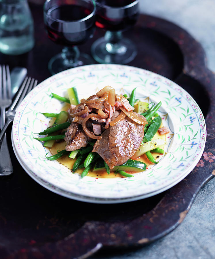 Lambs Liver With Bacon And Onions On A Bed Of Green Vegetables Photograph by Karen Thomas