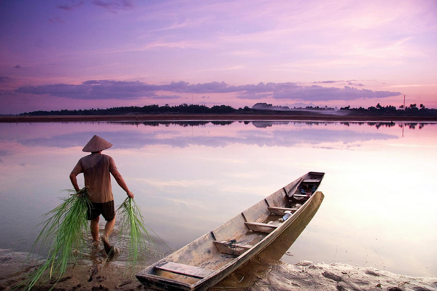 Laotian Man Walking Into Calm River Photograph by Matthew Micah Wright