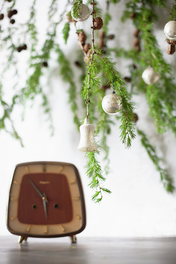 Larch Branches Decorated For Christmas Above Vintage Alarm Clock On Table Photograph by Alicja Koll