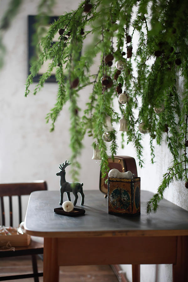 Larch Branches Decorated For Christmas Above Vintage Table Photograph by Alicja Koll