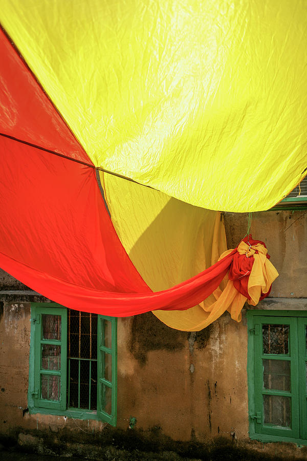 Large Yellow And Red Flag In Alley Photograph by Merten Snijders