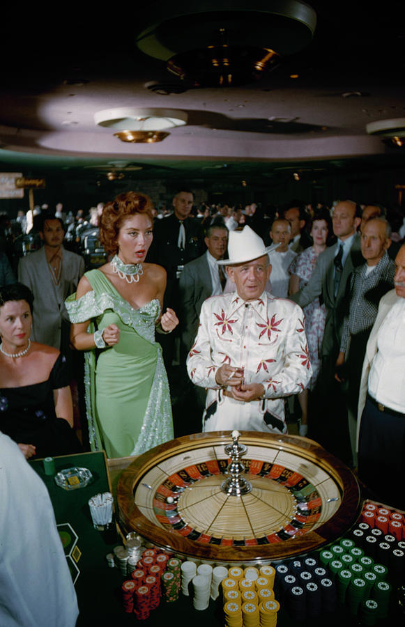 Las Vegas - Customers Rolling Dice At Photograph by Loomis Dean Las Vegas - Customers Rolling Dice At Photograph by Loomis Dean