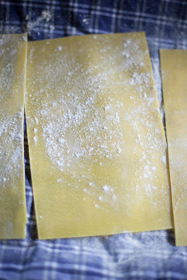 Lasagne Sheets With Flour On A Tea Towel Photograph by Eising Studio