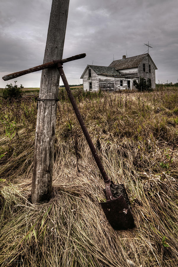 Last Post Hole Dug - Abandoned Stensby homestead with posthole digger propped against pole Photograph by Peter Herman