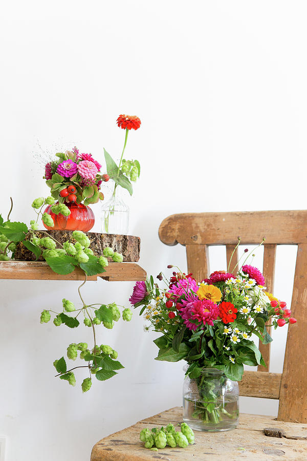 Late Summer Bouquets And Hop Vines On Wooden Table And Chair Photograph by Iris Wolf