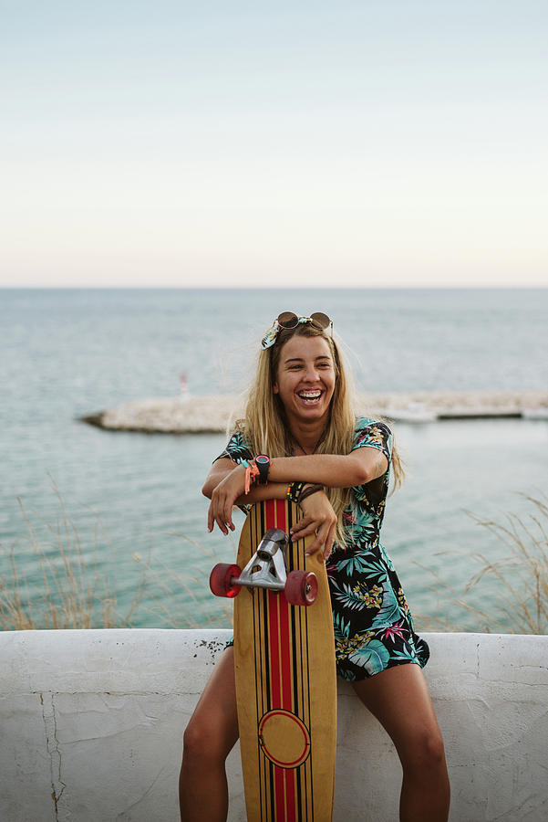 Summer Photograph - Laughing Female With Long Board Skate In Front Of Mediterranean Sea by Cavan Images