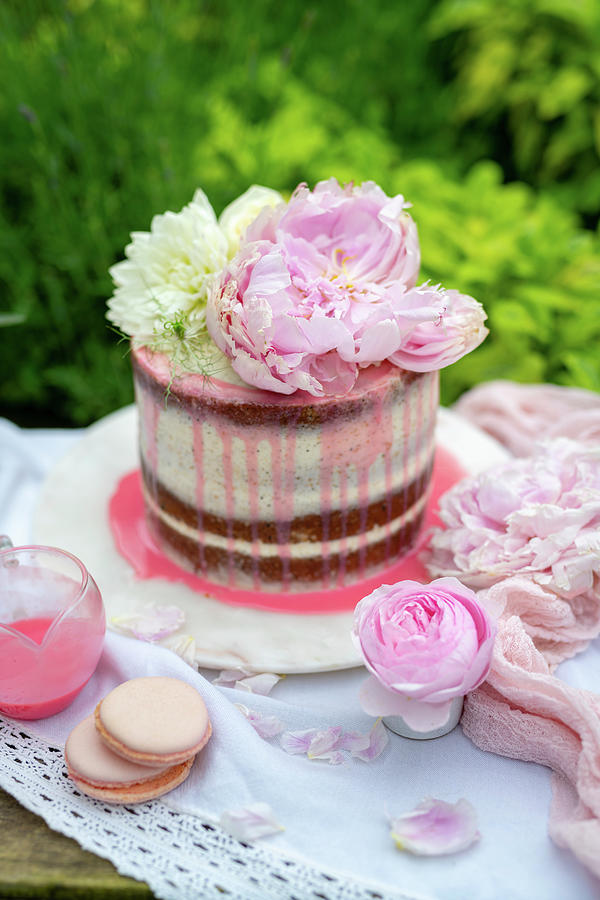 Layer Cake Decorated With Fresh Flowers In Garden Setting Photograph by Lucy Parissi