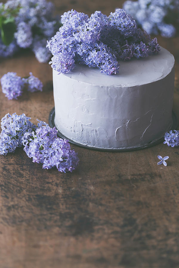 Layer Cake With Lilac Blossom, On A Rustic Wooden Surface Photograph by Malgorzata Laniak
