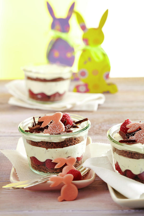 Layered Raspberry And Mascarpone Sponge Cake In Jars With Marzipan Bunnies Photograph by Teubner Foodfoto