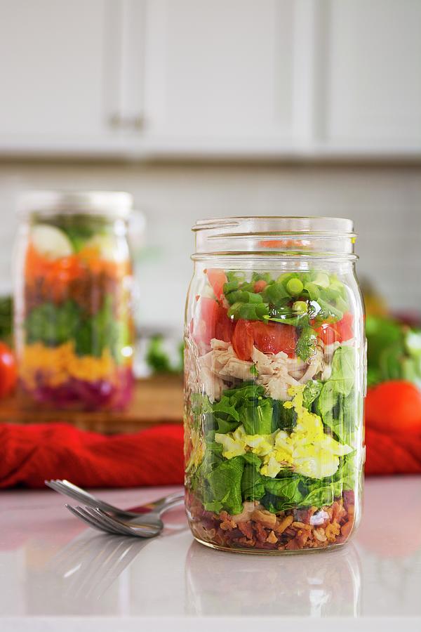 Layered Salad In Glass With Spinach, Beans, Cheese And Egg Photograph by Brian Enright