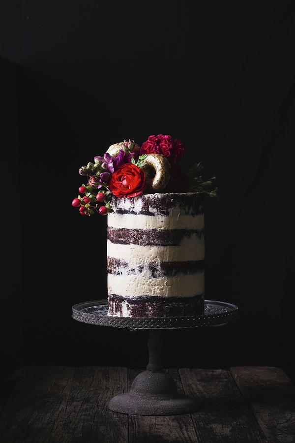 Layered Wedding Cake On Stand Decorated Witih Fresh Flowers And Gold Donuts Photograph by Rose Hewartson