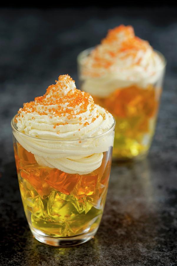Layered Yellow And Orange Jelly Topped With Whipped Cream And Orange ...