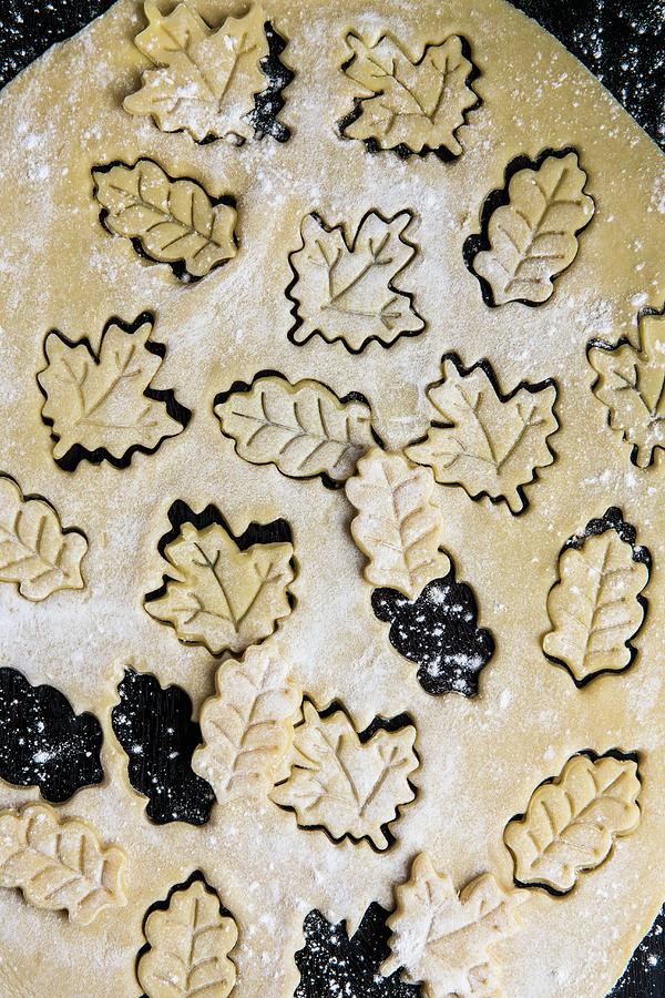 Leaf-shaped Biscuits Cut Out Of Biscuit Dough Photograph by Magdalena Hendey