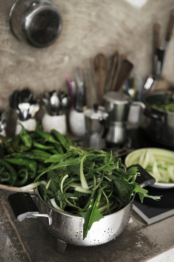 Leafy Vegetables In Metal Colander In Kitchen Photograph by Annette Nordstrom