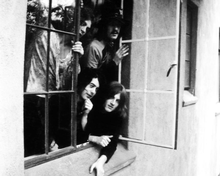 Robert Plant Photograph - Led Zeppelin Band Members Leaning Out Of Window At The Chateau Marmont by Globe Photos