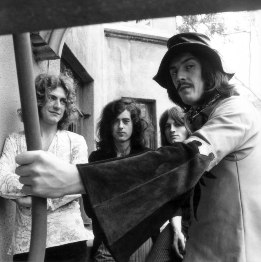 Robert Plant Photograph - Led Zeppelin, Shot From Under A Staircase, Standing Together, Robert Plant Smiling by Globe Photos