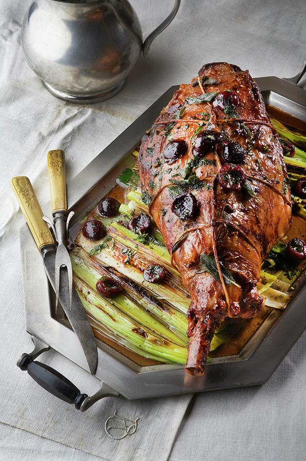 Leg Of Lamb On A Bed Of Leek With Cherries Photograph by Rose Hodges