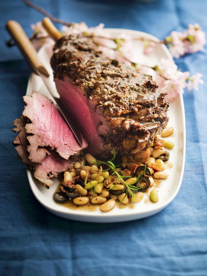 Leg Of Lamb With Flageolets Beans And Black Olives Photograph by Roulier-turiot