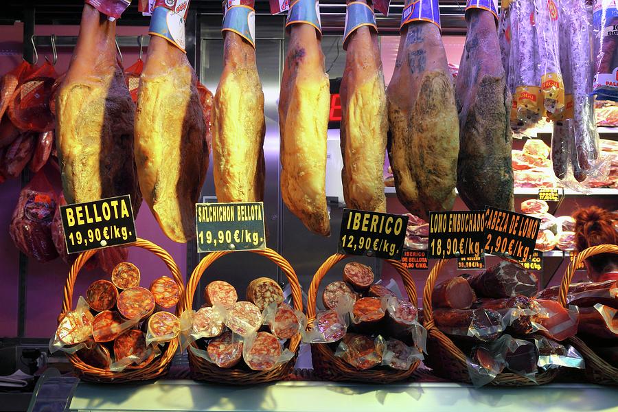 Legs Of Bellota Quality Iberian Ham And Various Salamis At A Market In Bilbao, Basque Country, Spain Photograph by Rainer Grosskopf