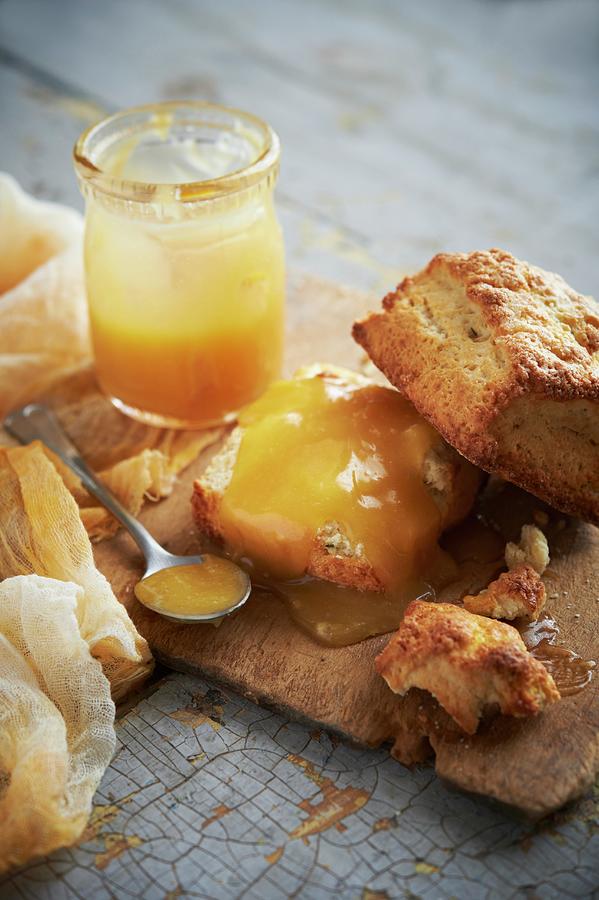 Lemon And Buttermilk Scones With Lemon Curd On A Rustic Wooden Board Photograph by Rannells, Greg