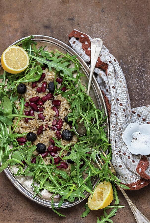 Lemon And Wholemeal Rice With Beans, Olives And Rocket Photograph by Adel Bekefi