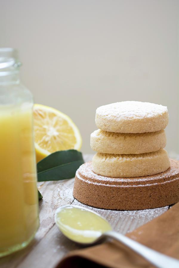 Lemon Biscuits Next To A Jar Of Lemon Curd Photograph by Marya Cerrone