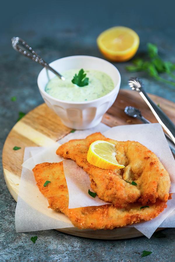 Lemon Chicken Cutlet With Mayonnaise With Yoghurt Parsley And Capers Photograph by Claudia Gargioni