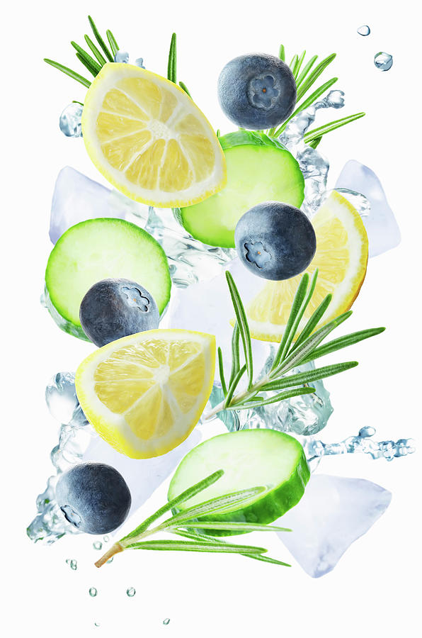 Lemon, Cucumber, Blueberry And Rosemary Flying With Ices And Water Splash Photograph by Natasha Arz