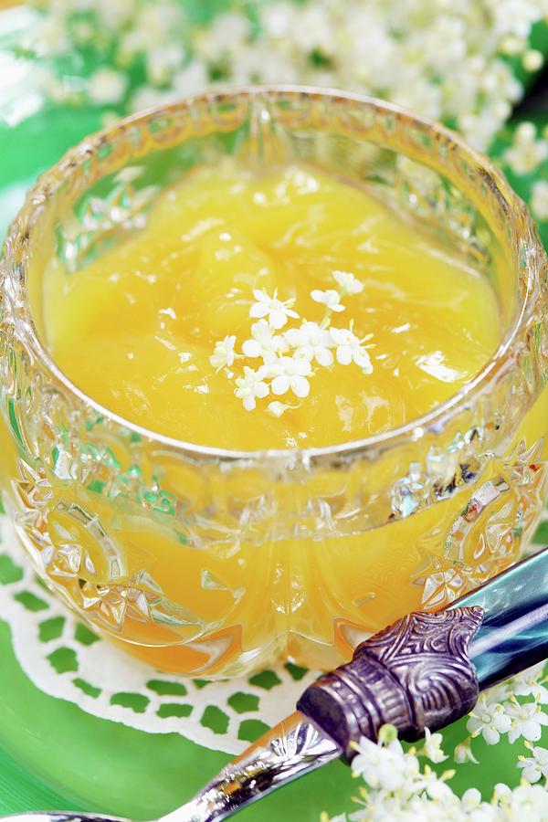Lemon Curd With Elderflowers In A Crystal Bowl Photograph by Angelica Linnhoff