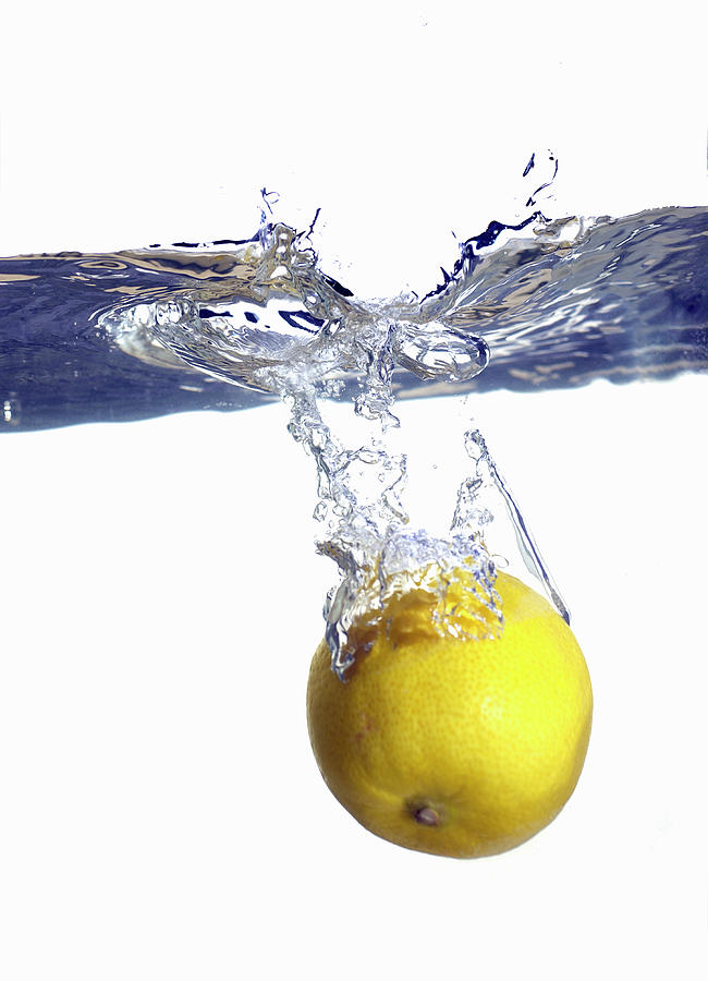 Lemon Dropping In Water, Close-up Photograph by White Packert