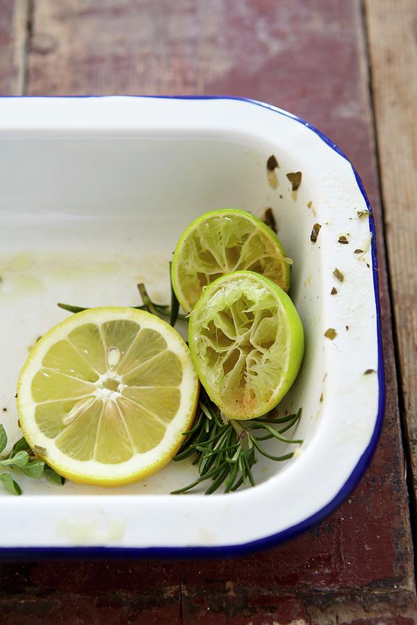 Lemon Slices, Squeezed Limes And Rosemary In A Roasting Tin Photograph by Kirchherr, Jo