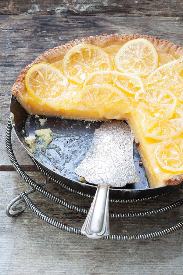 Lemon Tart In A Baking Dish, Partly Sliced Photograph by Food Experts Group